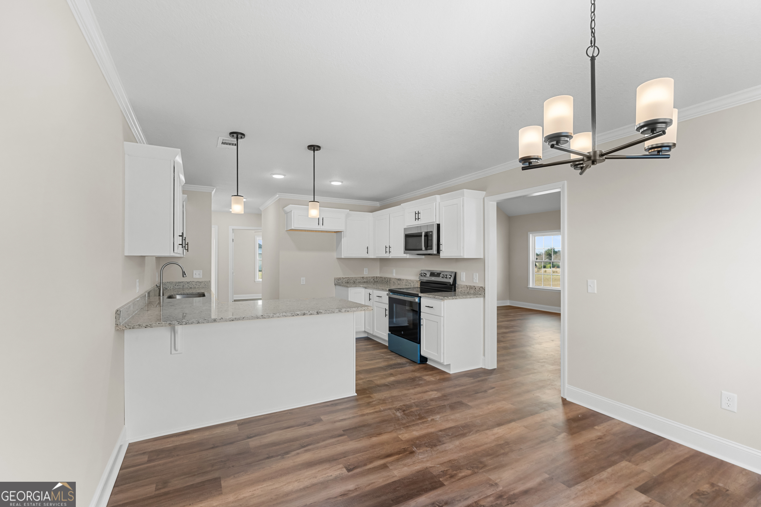 110 Enclave Court Statesboro, GA 30458 - Photo 5 of 16 a view of a kitchen with kitchen island a sink stainless steel appliances and wooden floor