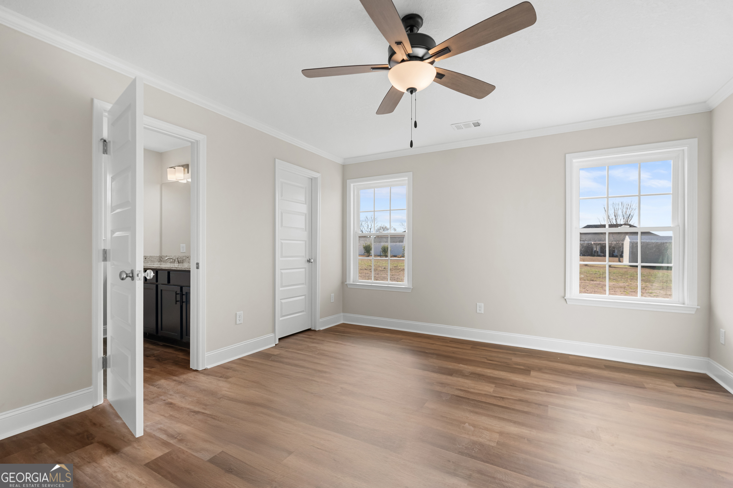 110 Enclave Court Statesboro, GA 30458 - Photo 7 of 16 a view of an empty room with a window and wooden floor