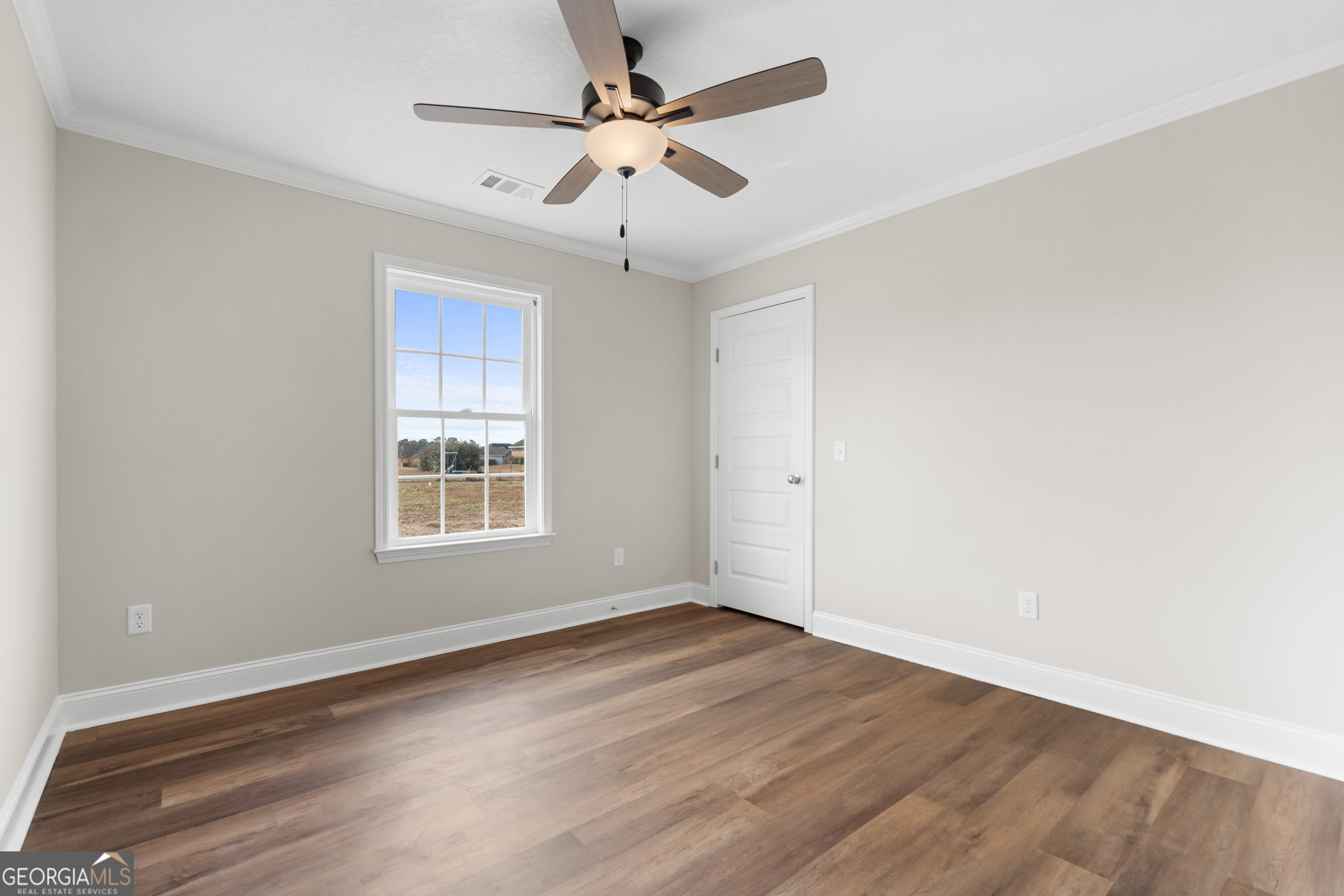 110 Enclave Court Statesboro, GA 30458 - Photo 10 of 16 an empty room with wooden floor ceiling fan and windows