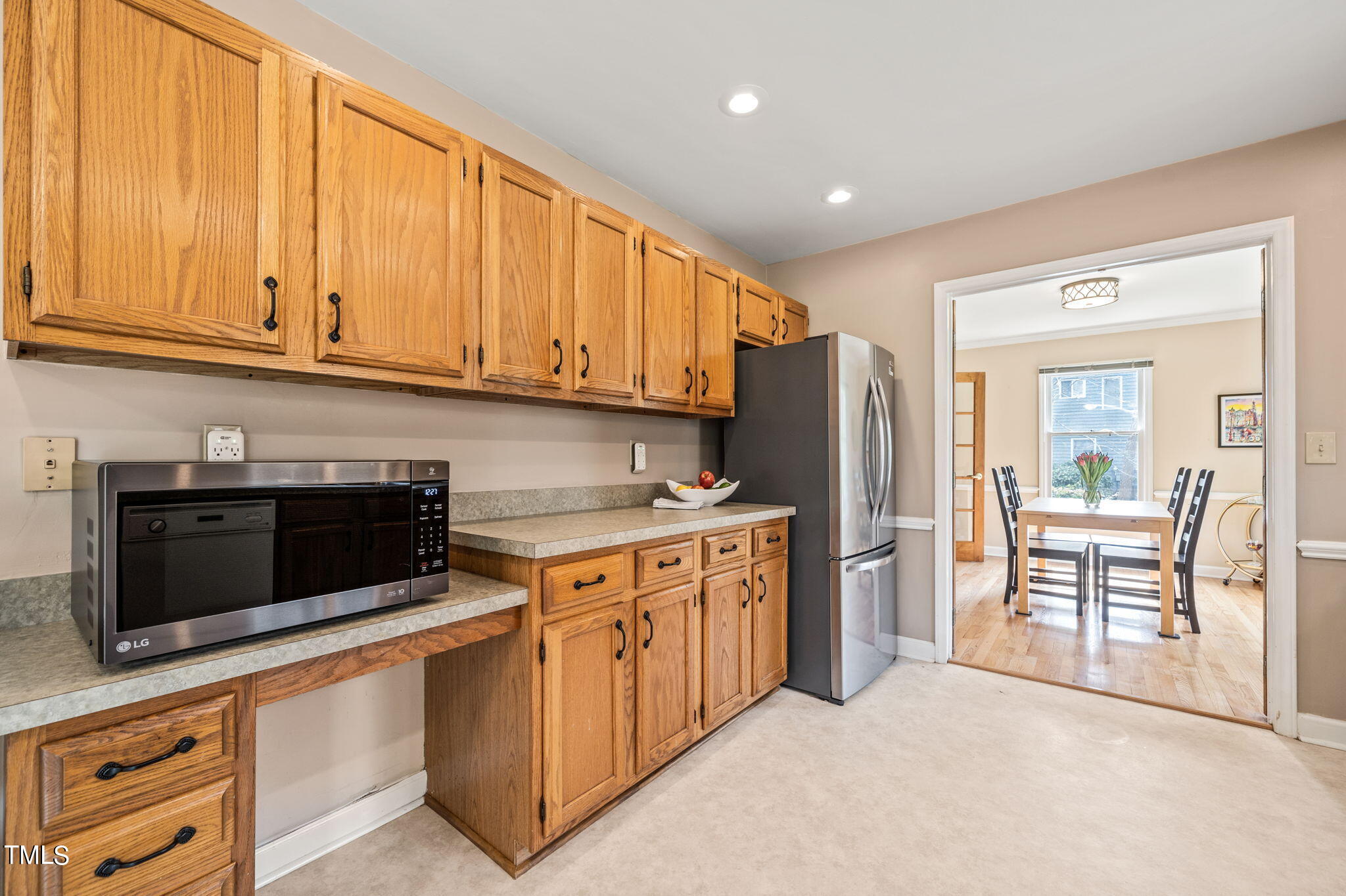 2415 Tryon Road Durham, NC 27705 - Photo 11 of 39 a kitchen with stainless steel appliances granite countertop a refrigerator oven a stove with white cabinets and sink