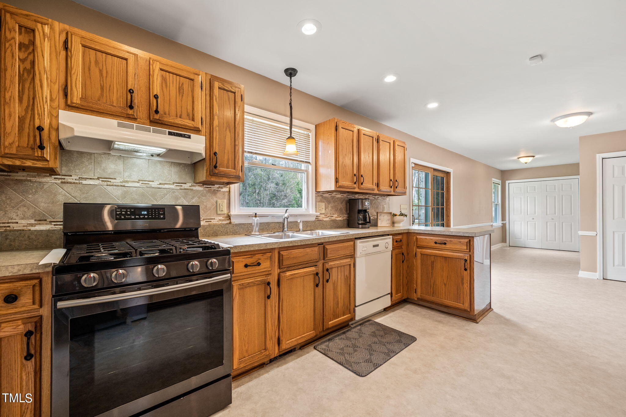 2415 Tryon Road Durham, NC 27705 - Photo 13 of 39 a kitchen with stainless steel appliances granite countertop a stove a sink and a microwave