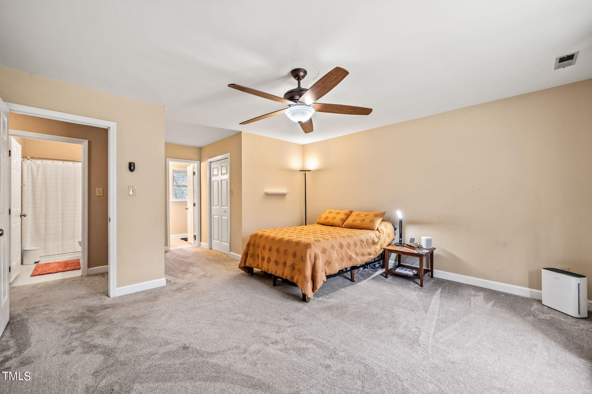 2415 Tryon Road Durham, NC 27705 - Photo 24 of 39 a bedroom with a bed and a ceiling fan