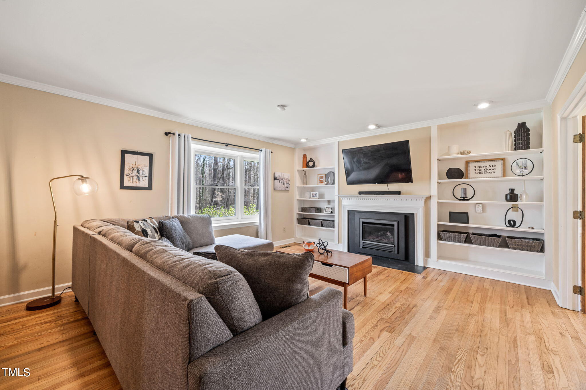 2415 Tryon Road Durham, NC 27705 - Photo 4 of 39 a living room with furniture a fireplace and a flat screen tv