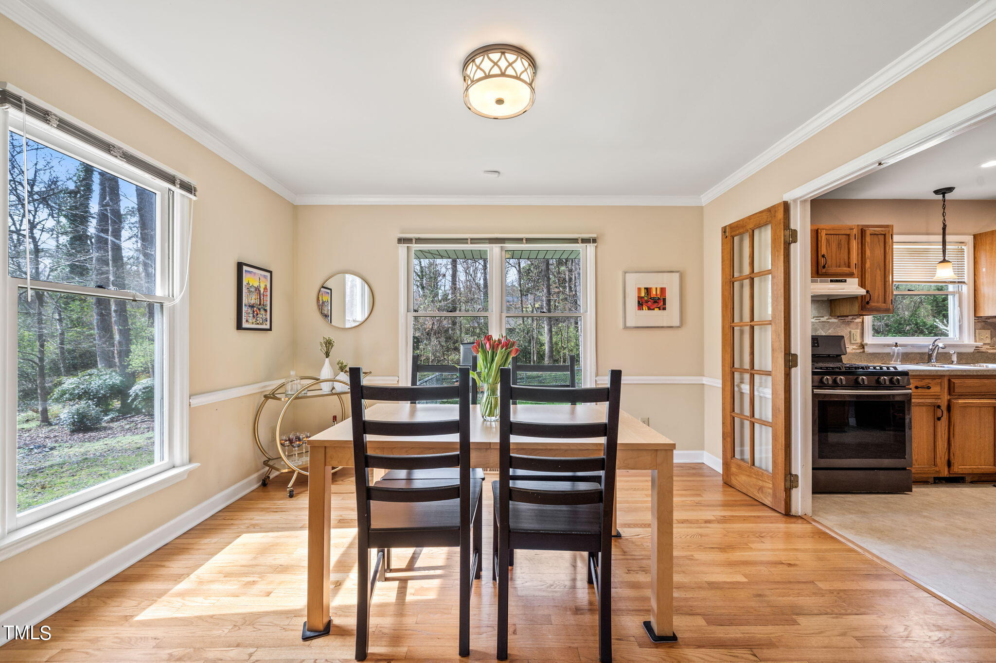 2415 Tryon Road Durham, NC 27705 - Photo 9 of 39 a view of a dining room with furniture large window and wooden floor
