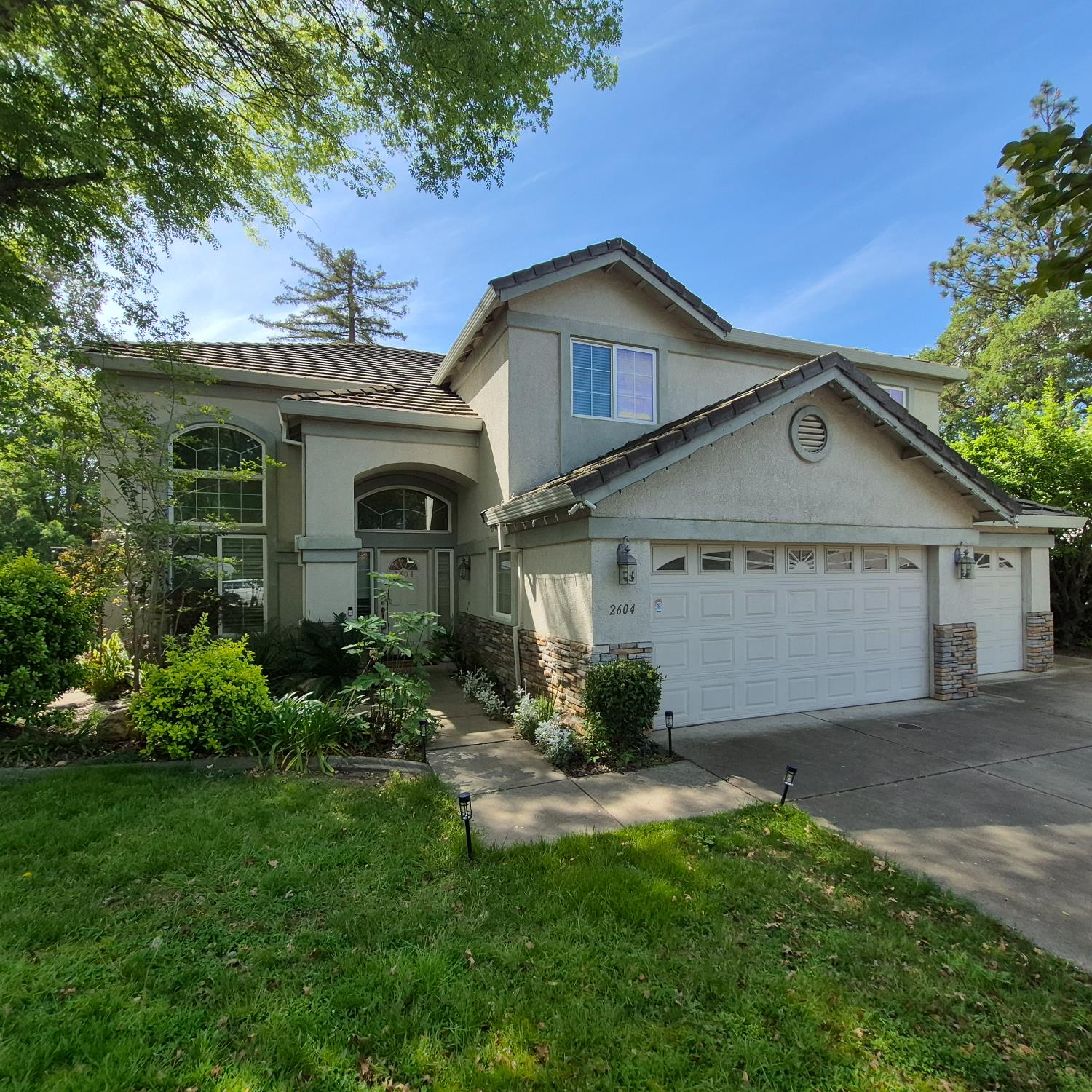 a front view of a house with a yard and garage