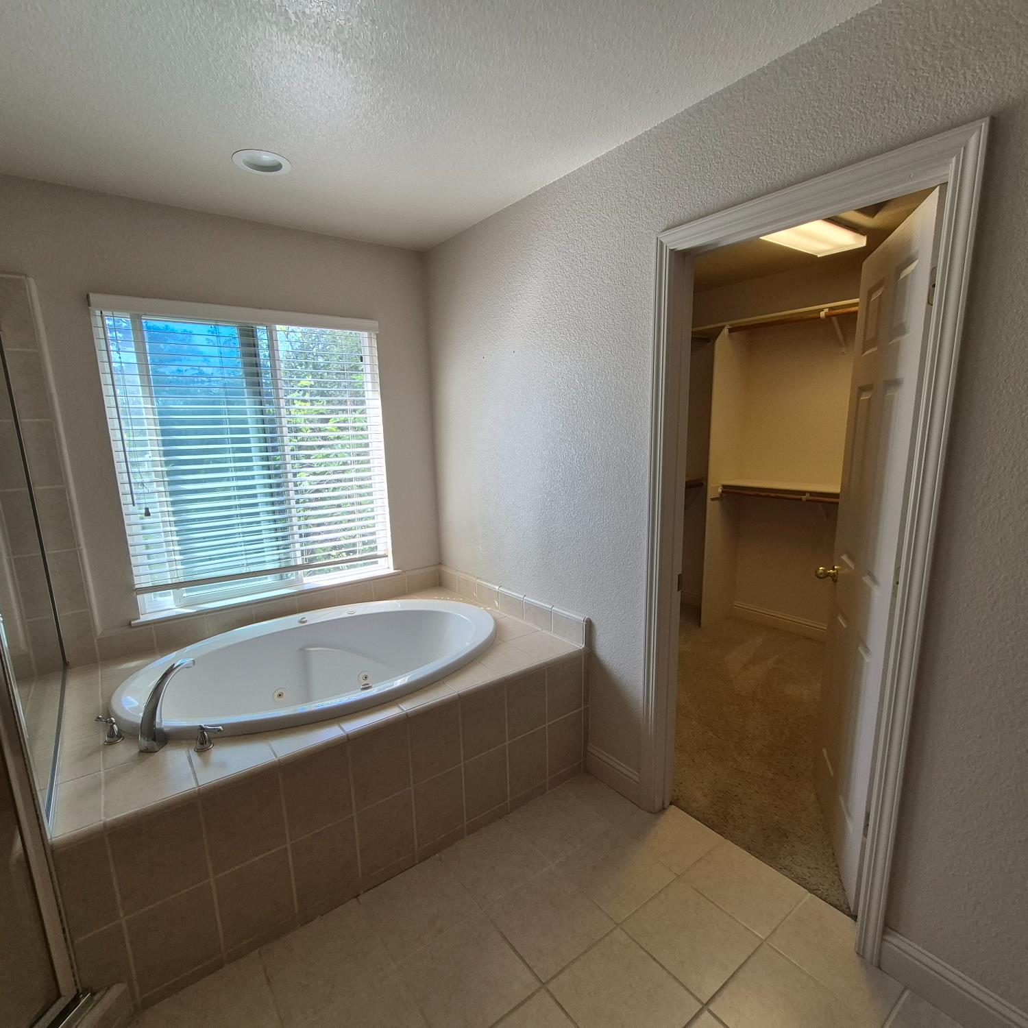 2604 Javan Lane Carmichael, CA 95608 - Photo 16 of 40 a spacious bathroom with a bathtub and a shower