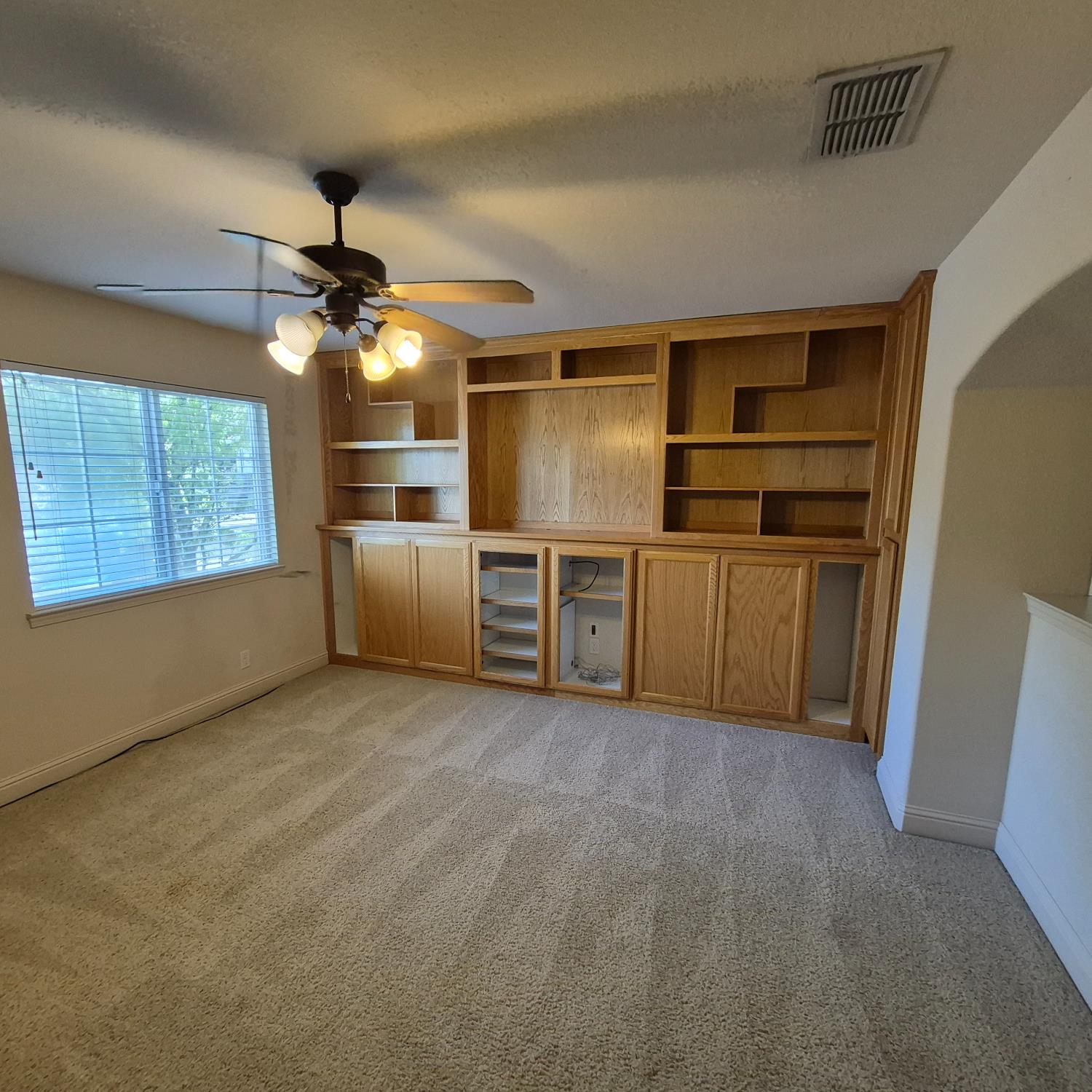 2604 Javan Lane Carmichael, CA 95608 - Photo 19 of 40 en empty room with windows and ceiling fan