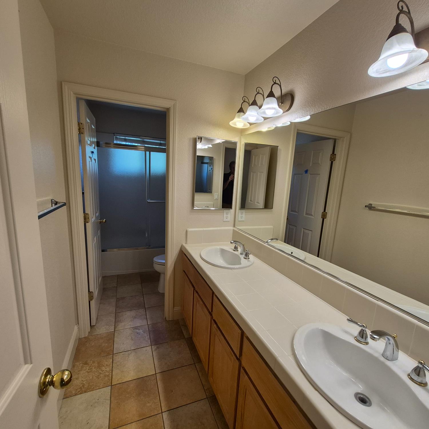 2604 Javan Lane Carmichael, CA 95608 - Photo 22 of 40 a bathroom with a double vanity sink a mirror and a shower