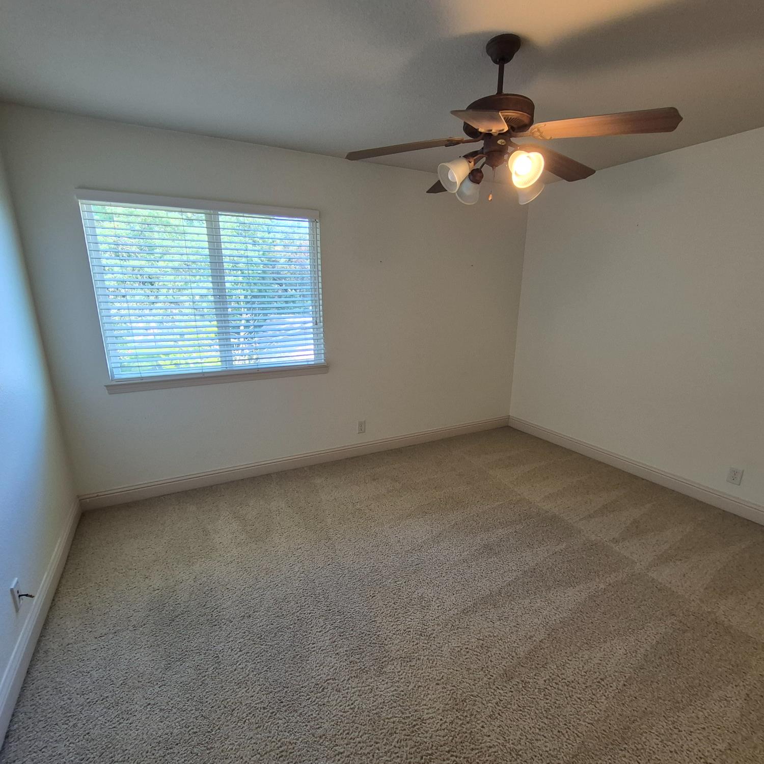 2604 Javan Lane Carmichael, CA 95608 - Photo 23 of 40 an empty room with a chandelier fan and window
