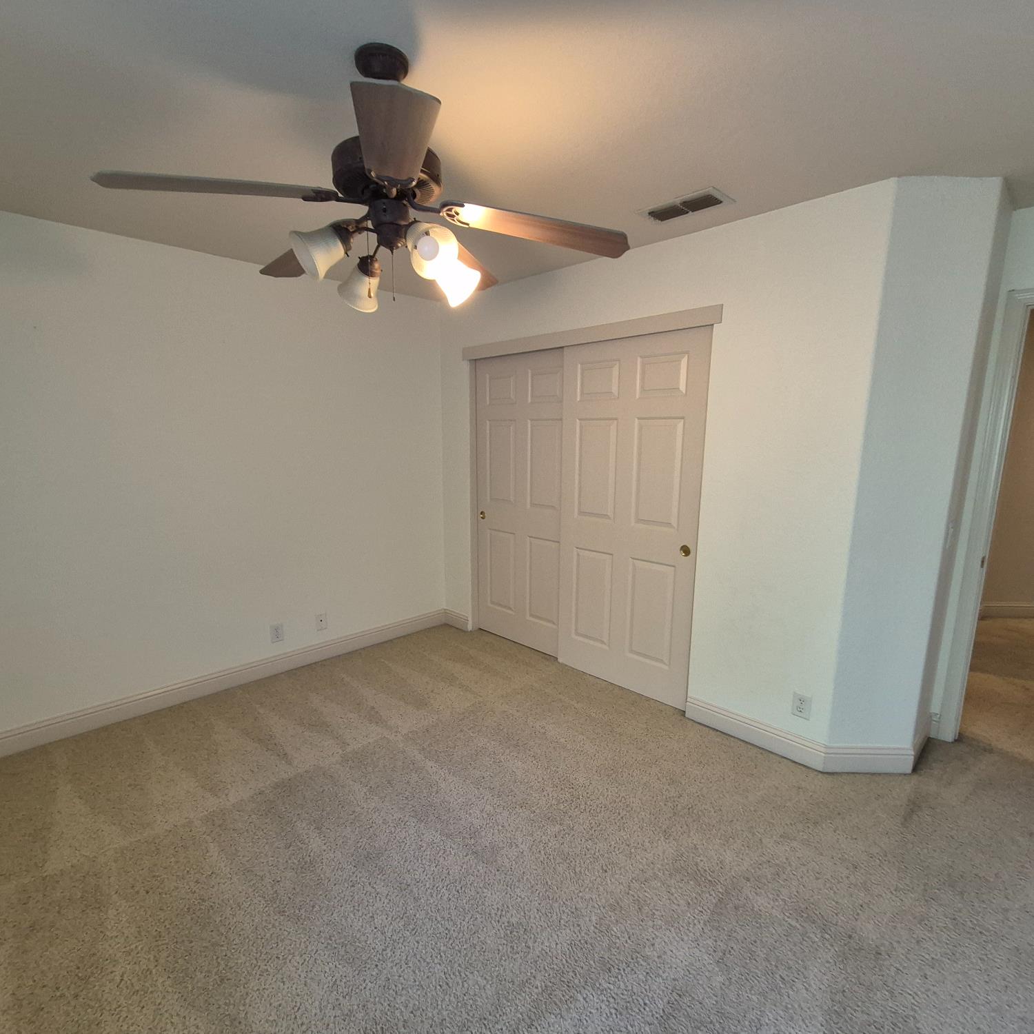 2604 Javan Lane Carmichael, CA 95608 - Photo 24 of 40 a view of a room with a ceiling fan and hardwood floor
