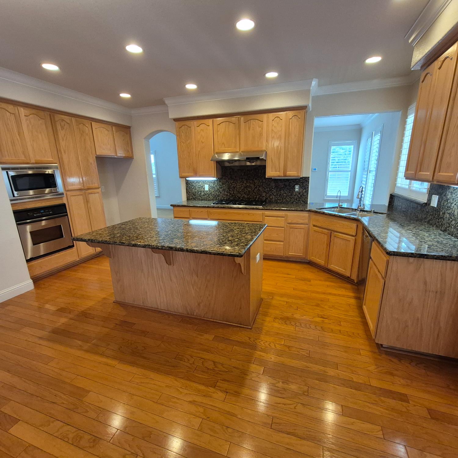 2604 Javan Lane Carmichael, CA 95608 - Photo 3 of 40 a large kitchen with stainless steel appliances granite countertop a large counter top and a stove