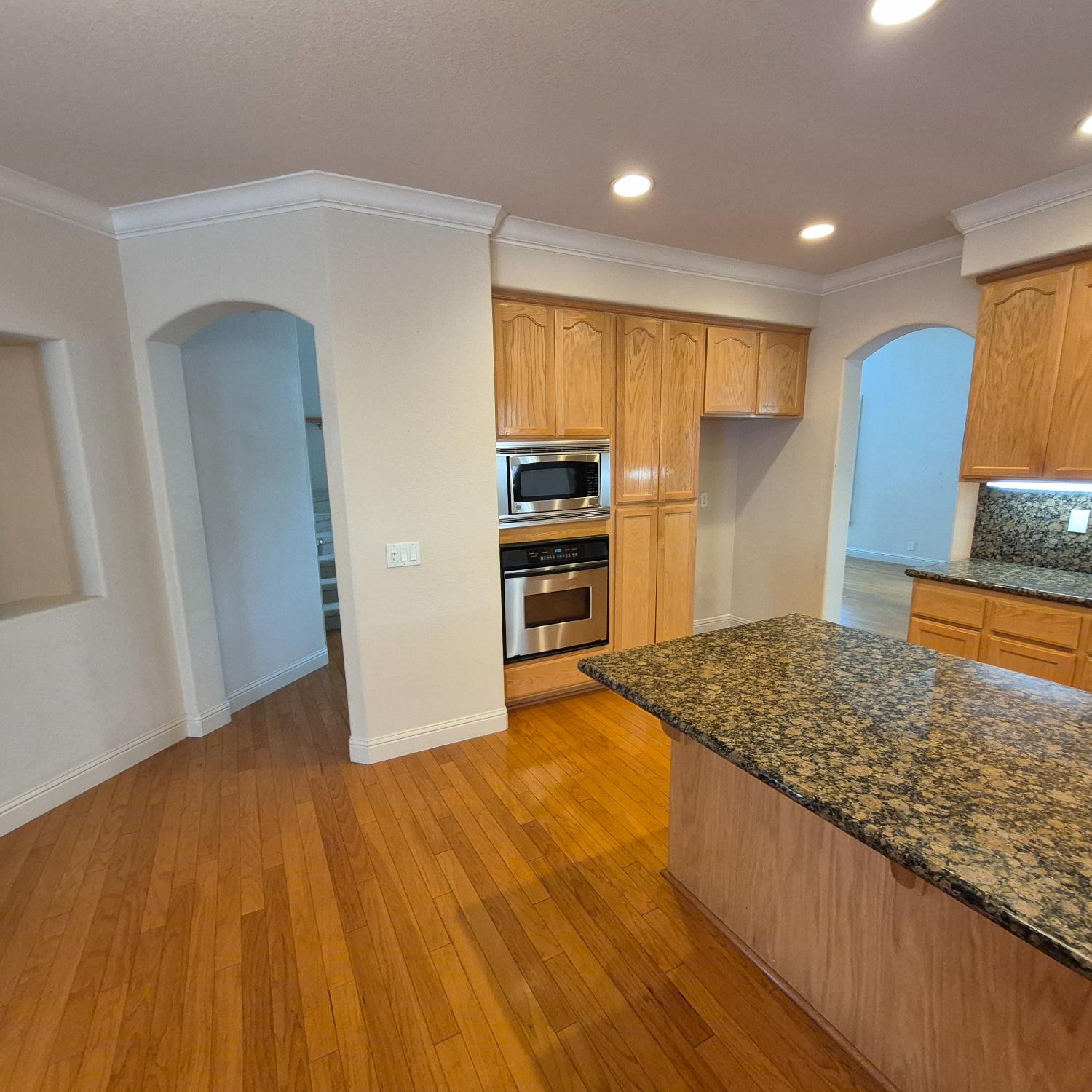 2604 Javan Lane Carmichael, CA 95608 - Photo 5 of 40 a view of kitchen and empty room with wooden floor