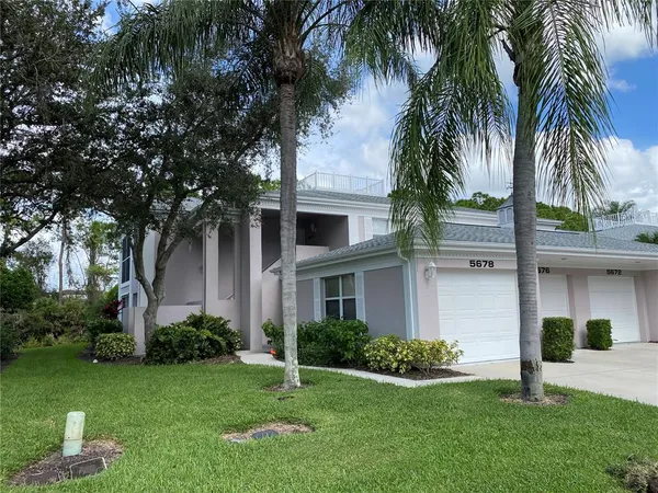 a front view of house with a garden