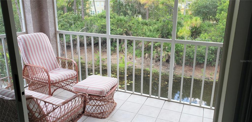 5678 Sheffield Greene Circle, Unit 76 Sarasota, FL 34235 - Photo 12 of 15 a view of a chair and table in the balcony