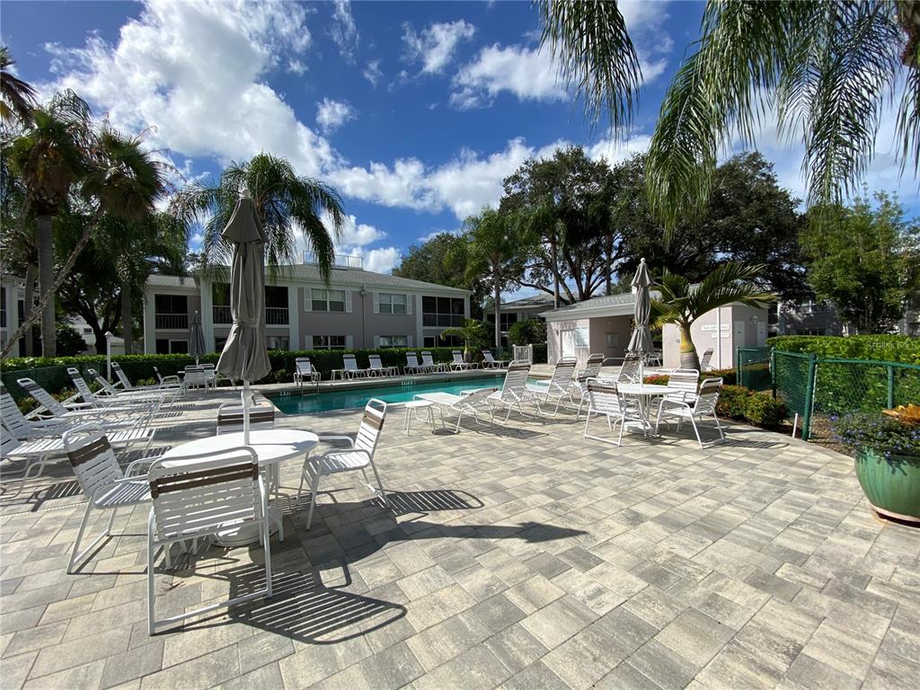 5678 Sheffield Greene Circle, Unit 76 Sarasota, FL 34235 - Photo 15 of 15 a view of a patio with table and chairs and potted plants