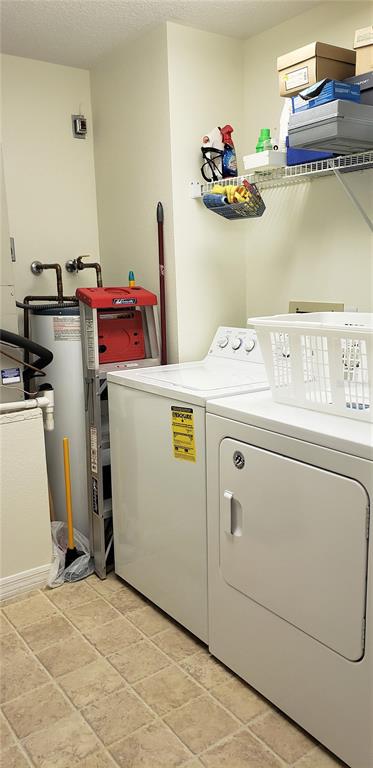 5678 Sheffield Greene Circle, Unit 76 Sarasota, FL 34235 - Photo 2 of 15 a utility room with dryer and washer