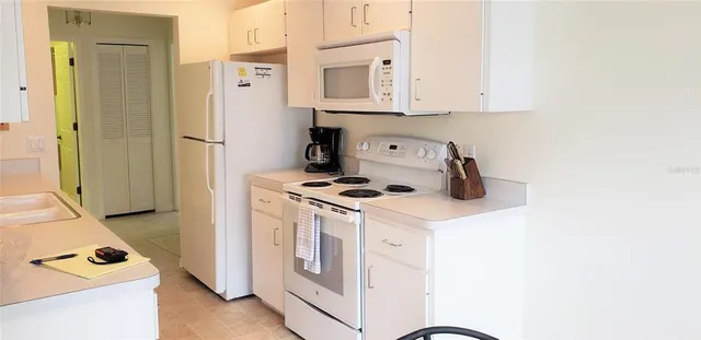 a kitchen with stainless steel appliances white cabinets and a stove