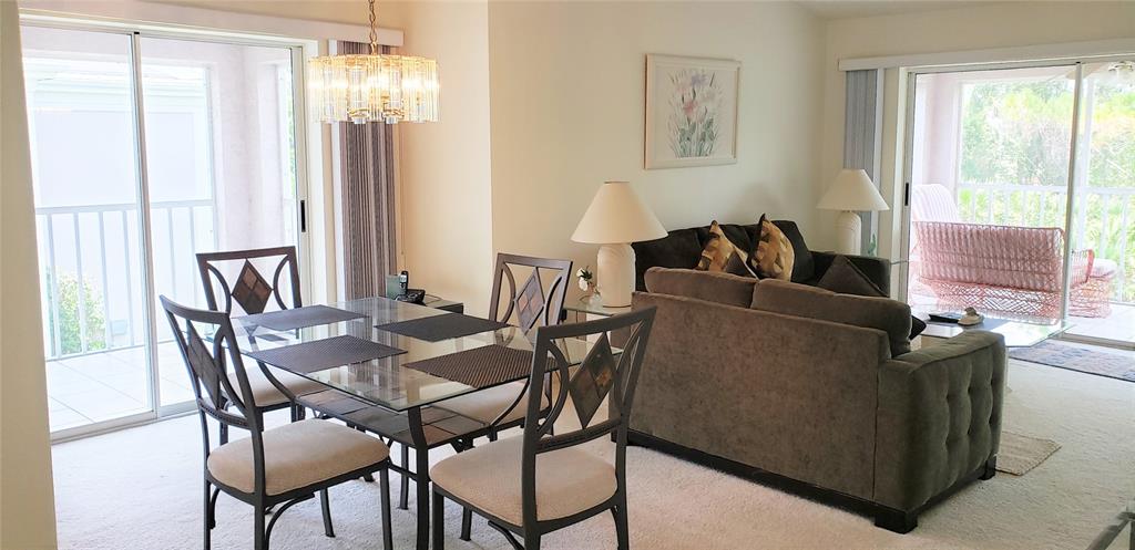 5678 Sheffield Greene Circle, Unit 76 Sarasota, FL 34235 - Photo 6 of 15 a view of a dining room with furniture window and outside view