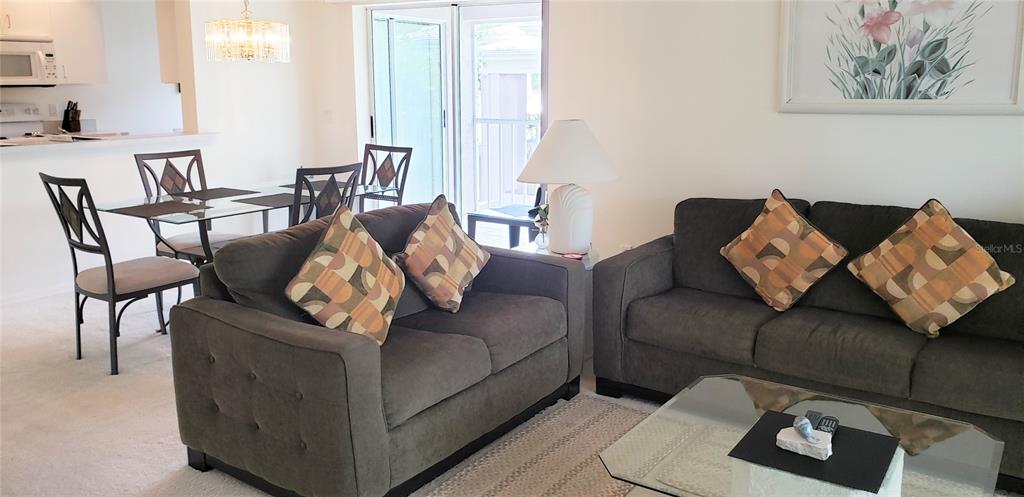 5678 Sheffield Greene Circle, Unit 76 Sarasota, FL 34235 - Photo 8 of 15 a living room with furniture and a couch