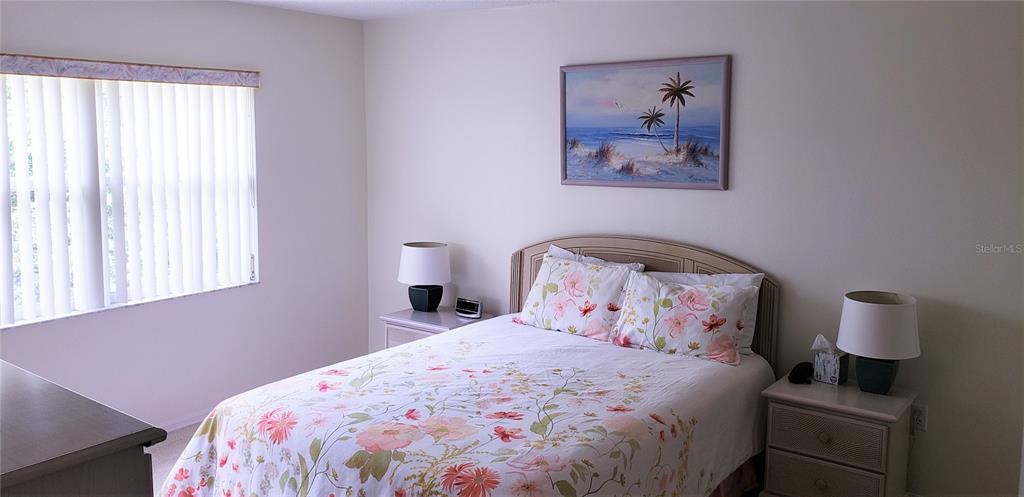 5678 Sheffield Greene Circle, Unit 76 Sarasota, FL 34235 - Photo 9 of 15 a bedroom with a bed and a window