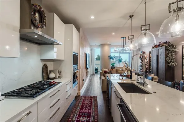 a kitchen with stove a sink dishwasher and a stove with wooden floor