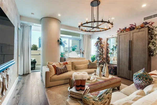 a living room with furniture a couch and a chandelier