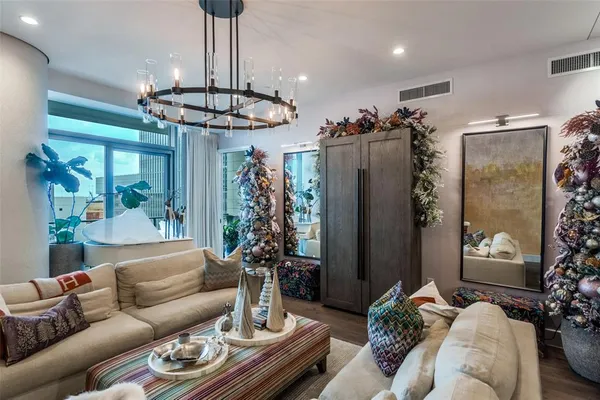 a living room with furniture and a chandelier