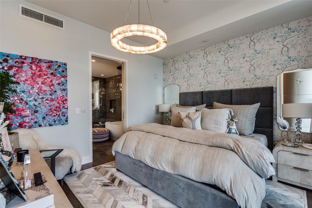 7901 Windrose Avenue, Unit 702 Plano, TX 75024 - Photo 19 of 40 a bedroom with a bed and a chandelier