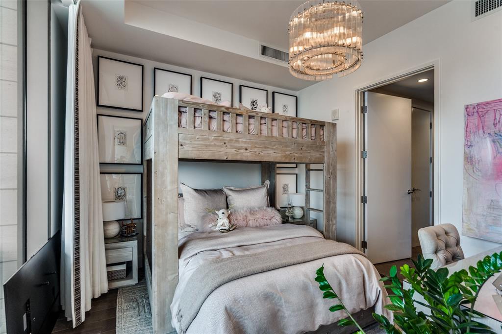 7901 Windrose Avenue, Unit 702 Plano, TX 75024 - Photo 23 of 40 a bedroom with a bed and a chandelier