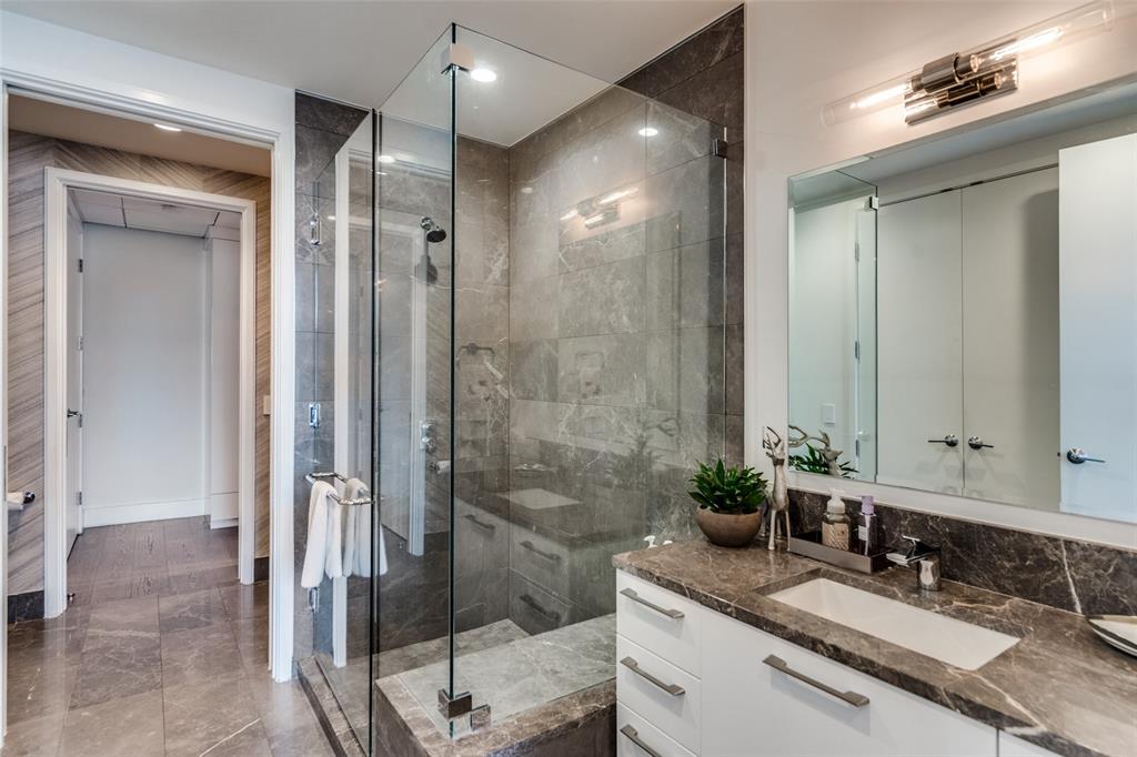 7901 Windrose Avenue, Unit 702 Plano, TX 75024 - Photo 24 of 40 a bathroom with a granite countertop sink mirror and shower