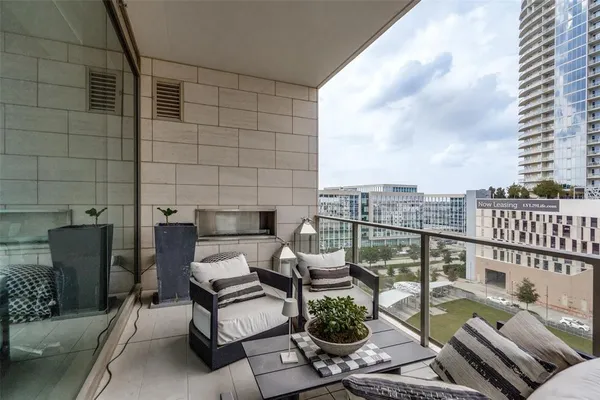 a balcony with wooden floor and furniture