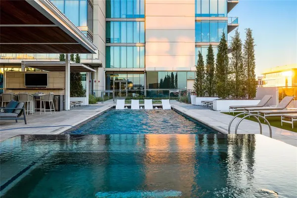 a view of a swimming pool with outdoor seating