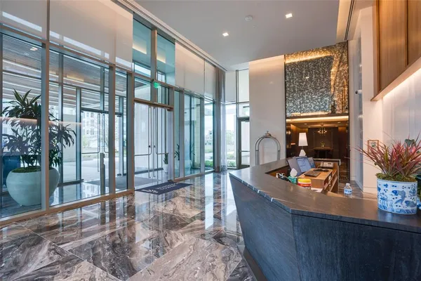 a dining room with furniture and a floor to ceiling window