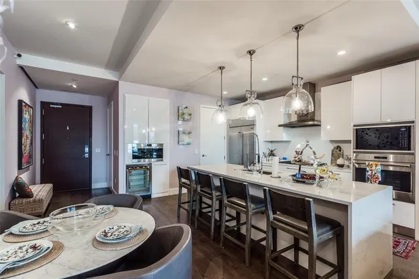 a kitchen with a dining table and chairs