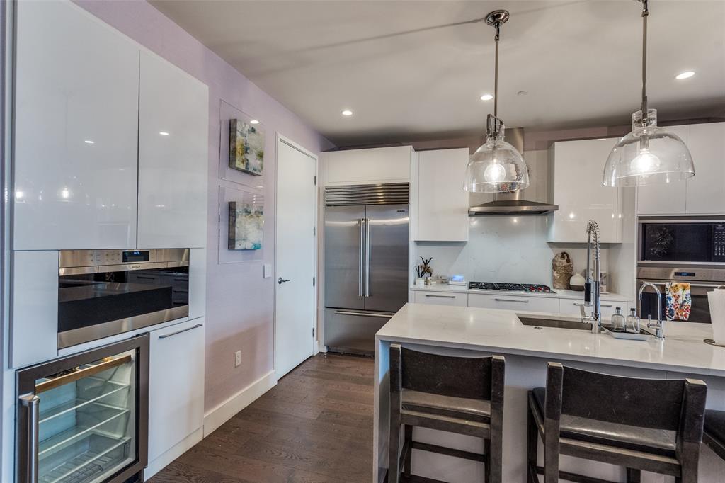 7901 Windrose Avenue, Unit 702 Plano, TX 75024 - Photo 6 of 40 a kitchen with kitchen island a sink appliances and cabinets