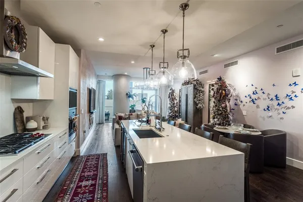 a kitchen with sink stove and refrigerator