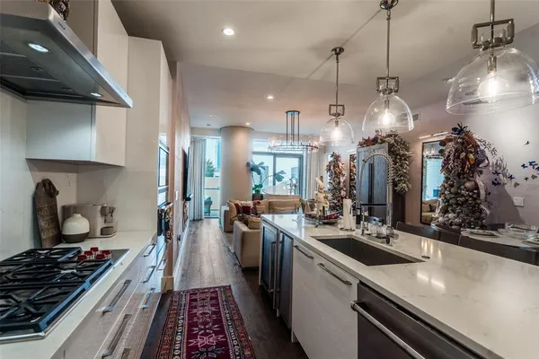 a kitchen with sink stove and cabinets