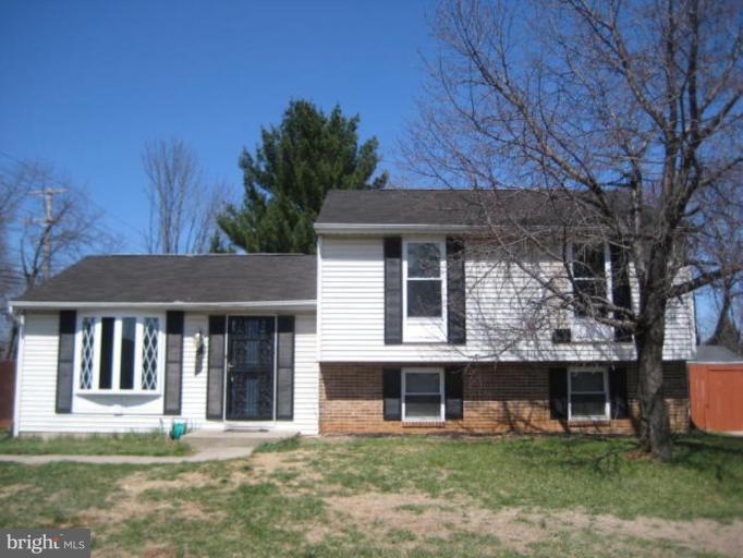 7928 Chipper Road Windsor Mill, MD 21244 - Photo 1 of 5 a front view of a house with a garden