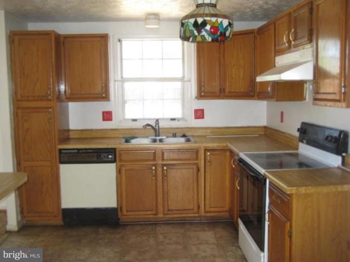 7928 Chipper Road Windsor Mill, MD 21244 - Photo 4 of 5 a kitchen with a sink stove and cabinets