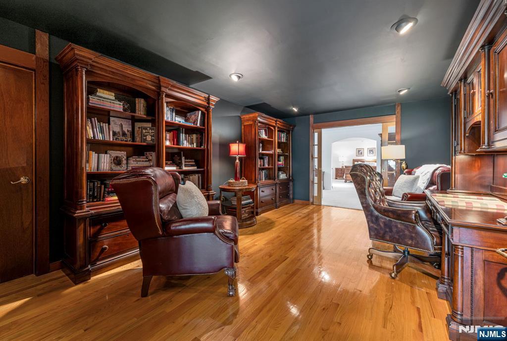 84 Bogerts Mill Road Harrington Park, NJ 07640 - Photo 22 of 47 a living room with furniture a bookshelf and a potted plant