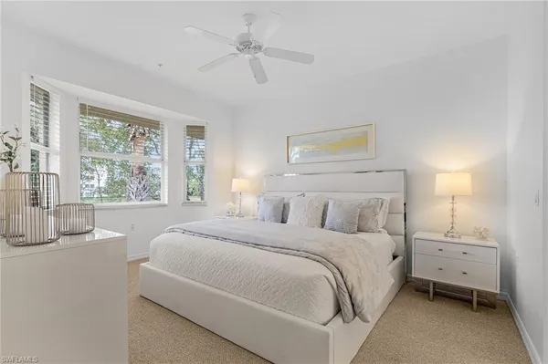a bedroom with a large bed and a large window