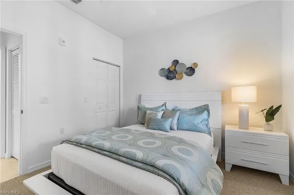 a bedroom with a bed and a cabinet