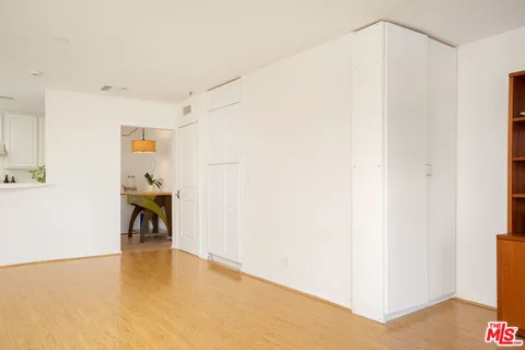 a view of a kitchen with a sink and a refrigerator