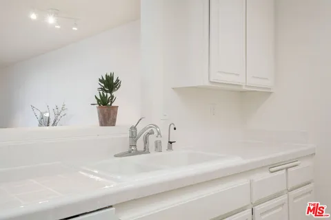 a kitchen with stainless steel appliances white cabinets and a sink