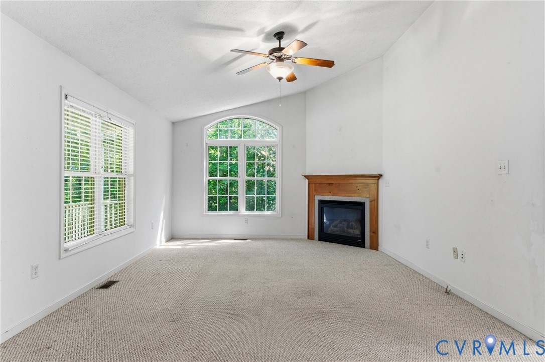 12654 Mt Olive Cohoke Road West Point, VA 23181 - Photo 8 of 31 an empty room with fireplace and windows