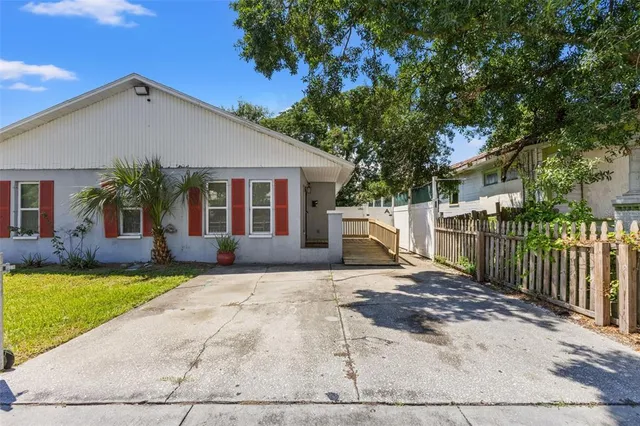 a view of a house with a yard and tree s