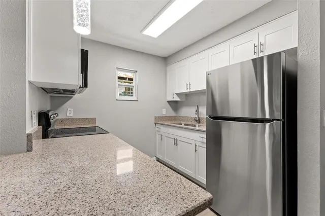 a kitchen with stainless steel appliances a refrigerator sink and stove