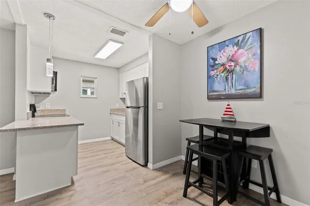 a view of a kitchen area with furniture and wooden floor
