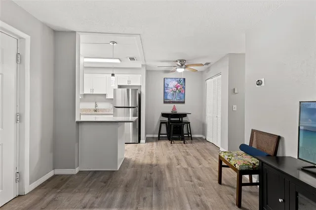a kitchen with cabinets and wooden floor