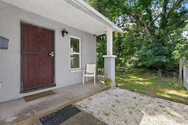 a chair and table in a backyard of the house